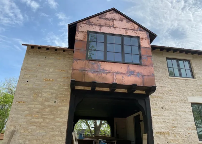 Copper metal panel facade on a stone building for Metal Roof Coating in Moore